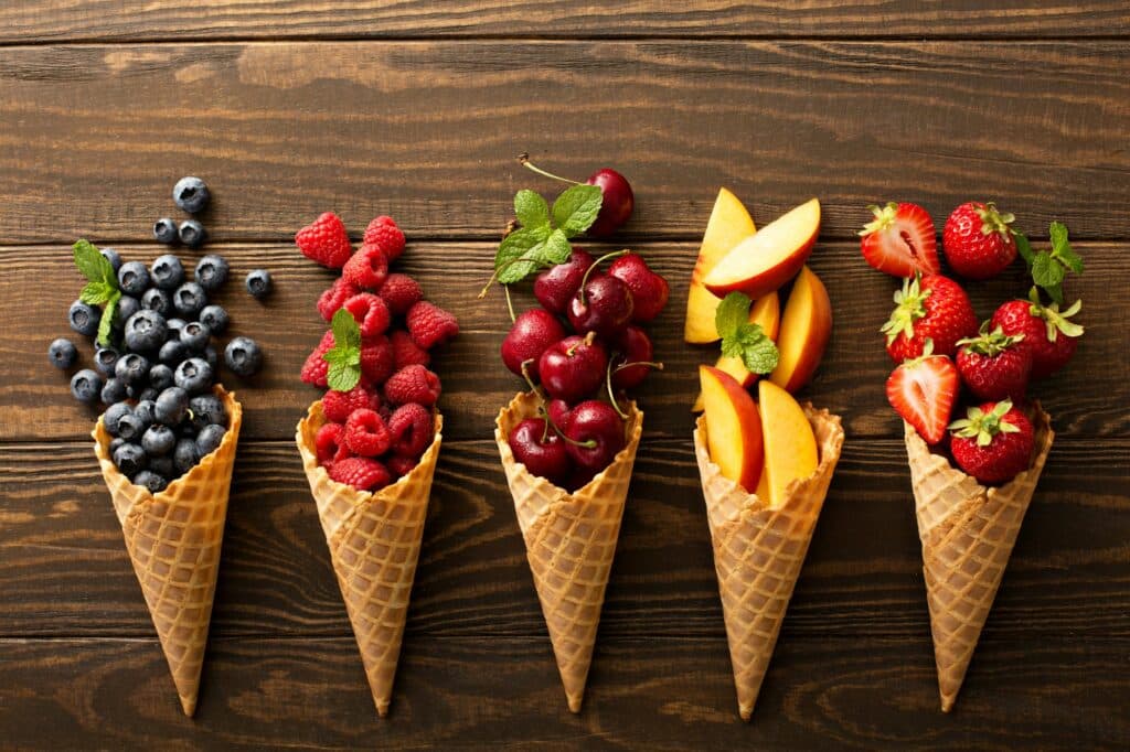 Fresh fruit and berries in waffle cones