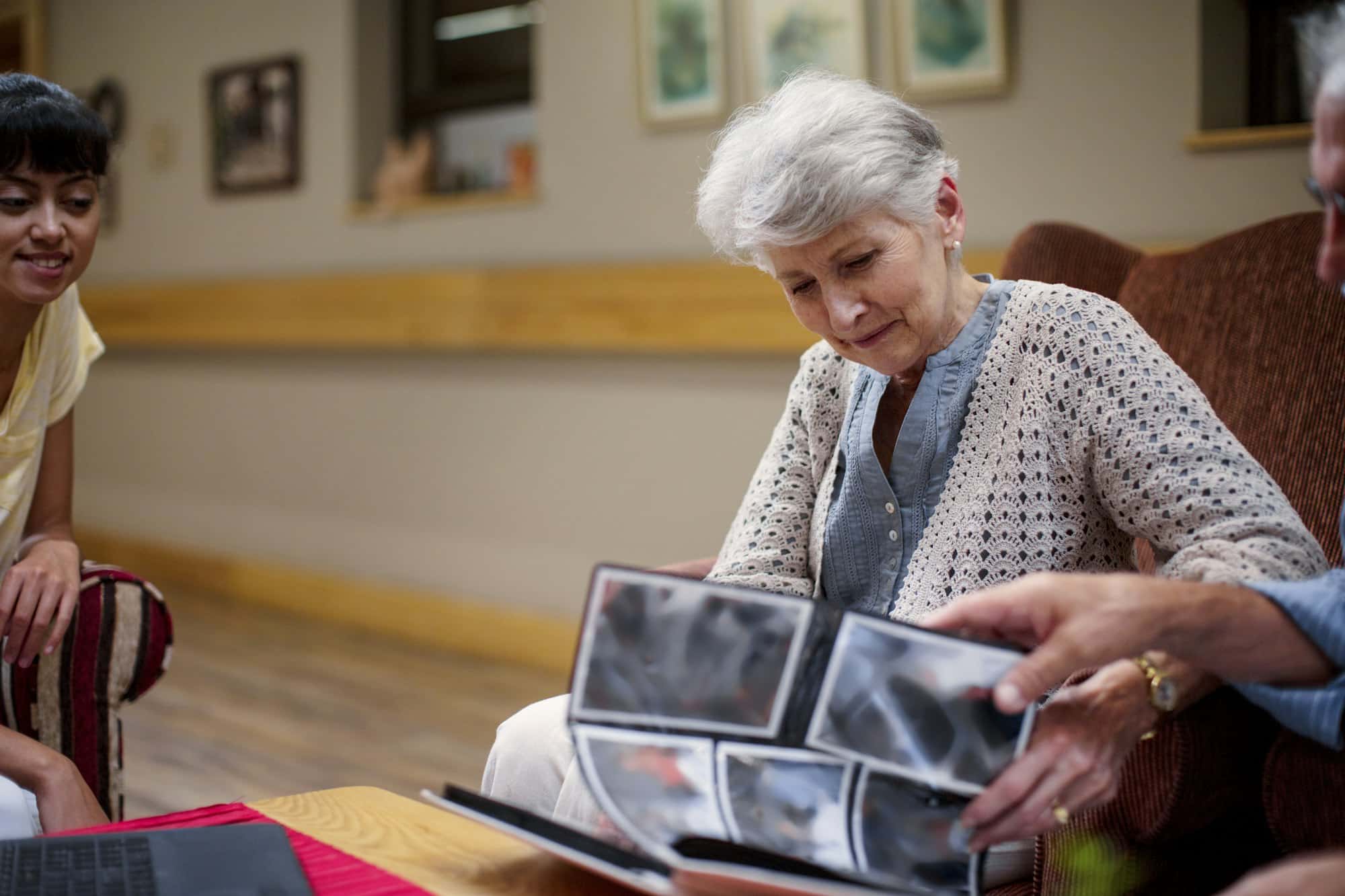 Seniors at retirement home looking at photo albums